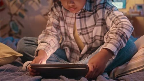 Child Using Tablet with Headphones at Home