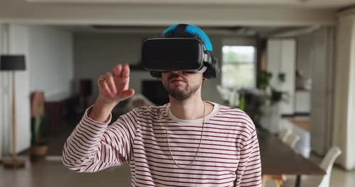 Man Wearing VR Headset Interacting with Virtual Reality
