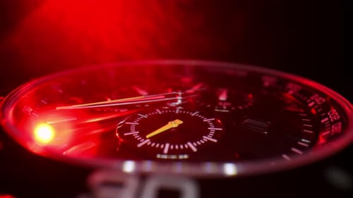 Macro Closeup of a Luxury Chronograph Watch Illuminated By Intense Red Light The Scene Highlights