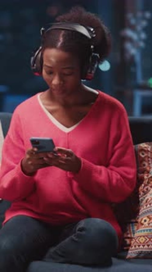 Woman Relaxing at Home with Smartphone