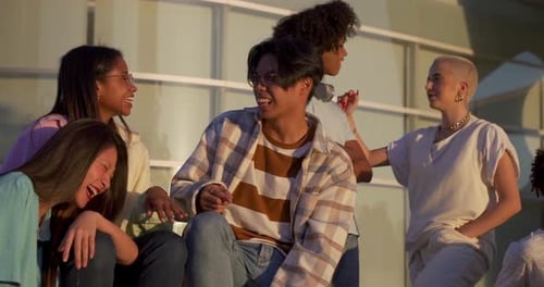 Big Group of Happy Teenage Friends Talking in a Bench in the Street of the Student Campus