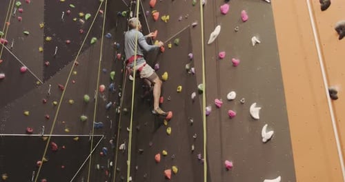Man Climbing Indoor Rock Climbing Wall