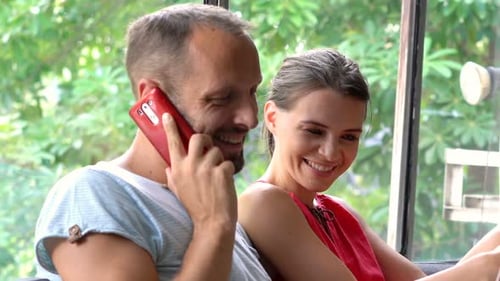 Couple Relaxing with Laptop and Phone Indoors