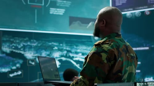 Man With Laptop in a Futuristic Command Center