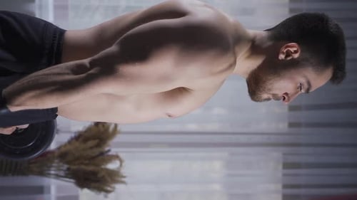 Vertical Video of Young athlete man is trying to have a more muscular and shapely physique.