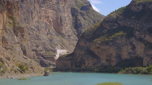 Sunlit Rocky Precipice With Tranquil Water Bright Landscape Of Stratified Rocks And Gentle Water