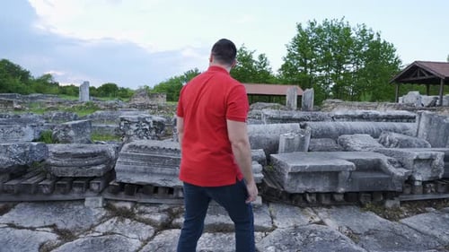 Follow Shot of Man Walking Among Roman Ruins at Sunset – Nicopolis ad Istrum, Bulgaria