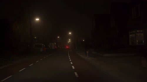 Driving on Dark City Street at Night