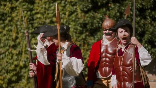 Figures in Costume Hold Spears and Rifles
