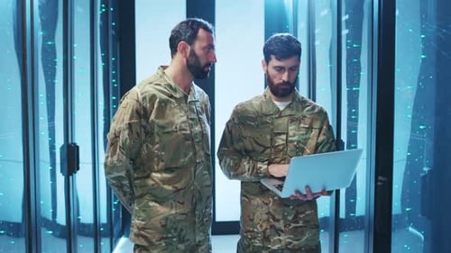 Technicians in Data Center Working with Laptop