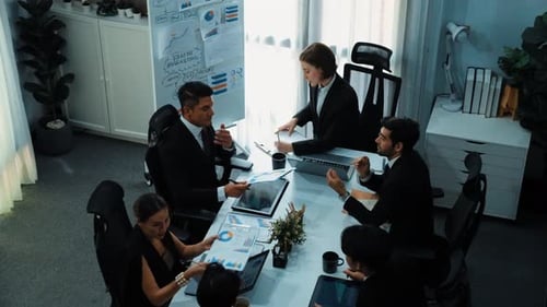 Top view of female leader looking financial statistic at meeting. Directorate.