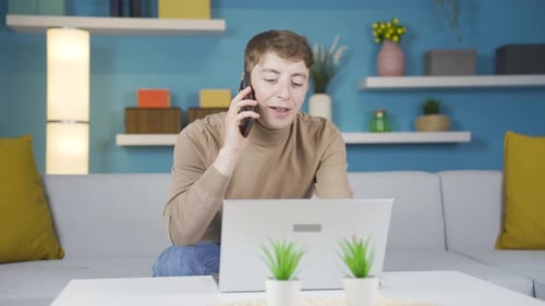 Adult Talking on the Phone While Using Laptop