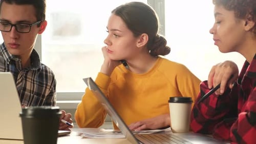 Young Adults Discuss Project at Workplace