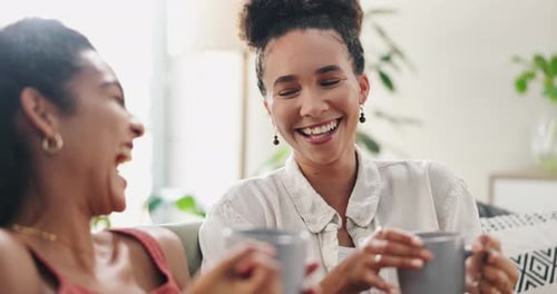 Laughing Women Enjoy Coffee Together Indoors