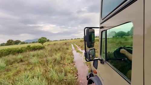 4x4 off road vehicle driving through mud puddles in Cabañeros National Park, wildlife safari style a