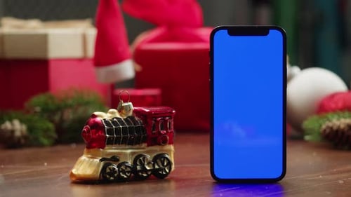 Phone with Green Screen Chroma Key Near Christmas New Year Background Vibes of Winter Holiday Red