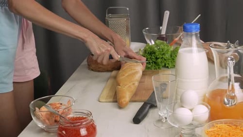 Women Making Food and Slicing Bread