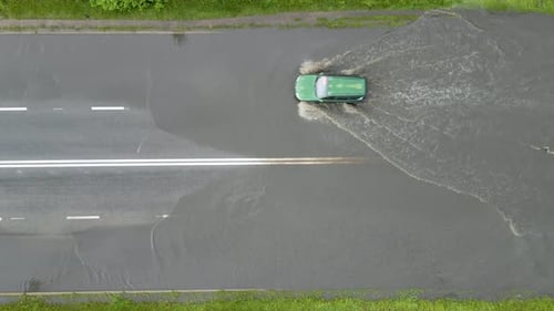 Aerial View of City Traffic with Cars Driving on Flooded Street After Heavy Rain
