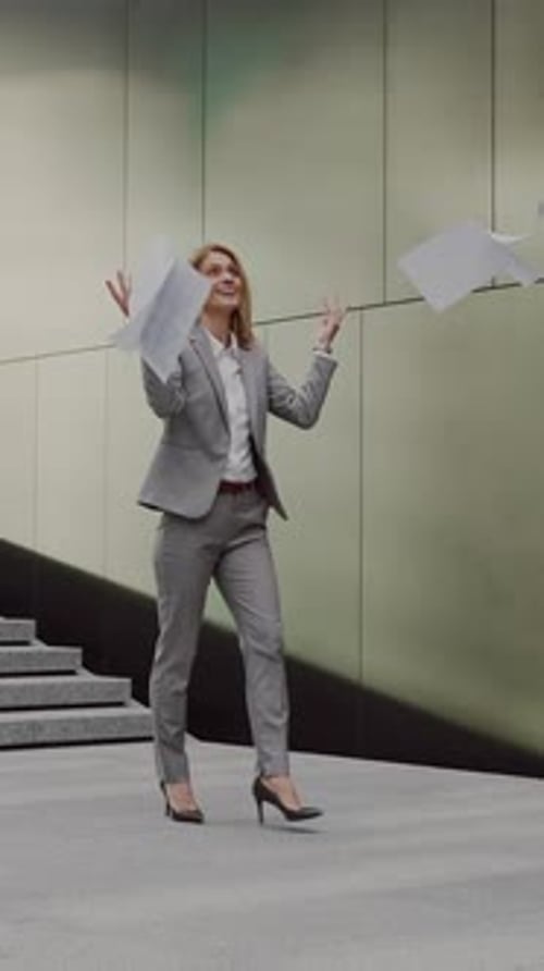 Happy Business Woman Throwing Up Documents Outdoors