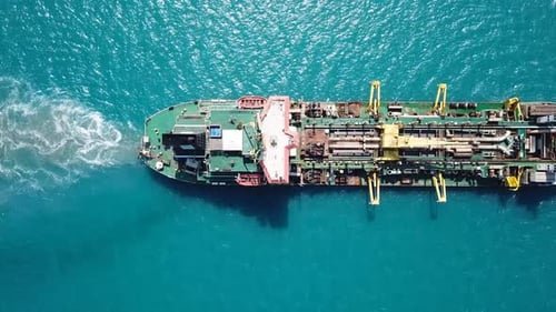 Trailing Suction Hopper-Dredger ship roaring across the sea
