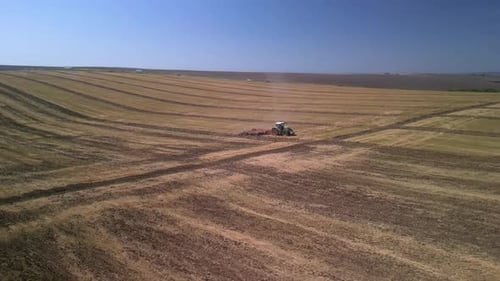 Tractor working on the field doing tillage with cultivator