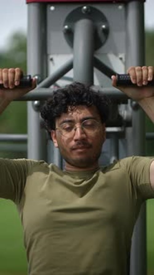 Man Working Out on Outdoor Exercise Equipment