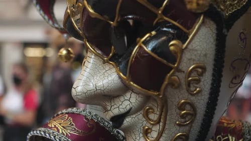 Detailed close up of Venezia carnival mask with city street in background