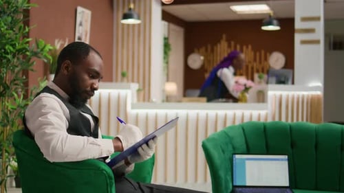 Hotel Employee Working in Elegant Lobby