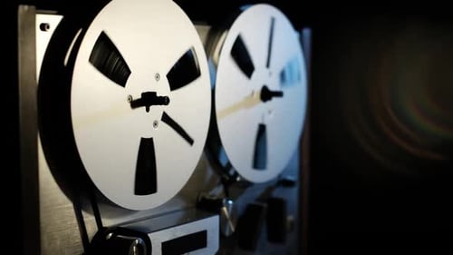 Vintage Reel-to-Reel Tape Recorder in Dark Environment