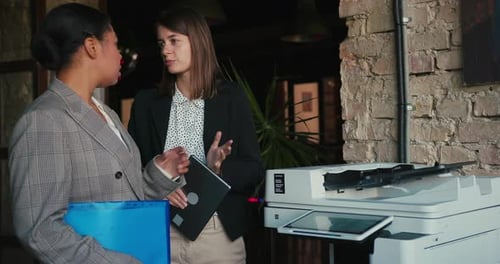Businesswomen Review Document and Exchange Professional Opinions