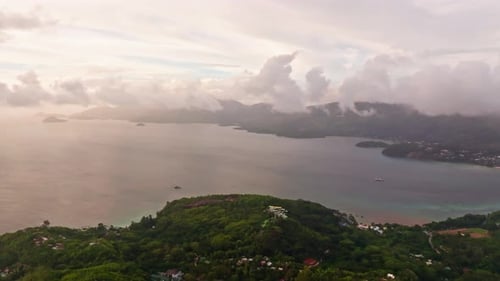 Aerial drone shot of picturesque sunset cloudscape on Mahè island, Seychelles. High view of the coas