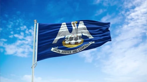 Louisiana State Flag Waving in Wind Against Blue Sky