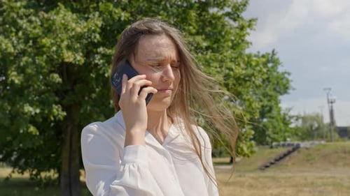 Angry businesswoman speaking to contractor on smartphone, portrait view
