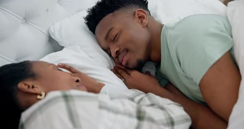 Couple Sleeps Soundly Holding Hands in Bed