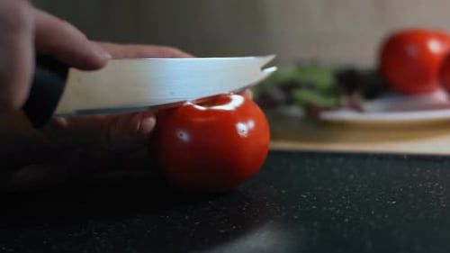Fresh Red Tomato Sliced on Cutting Board