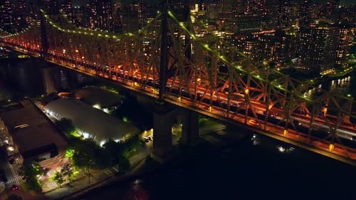 Gorgeous lighting of Queensboro Bridge at night. Stunning city scenery of New York at backdrop.