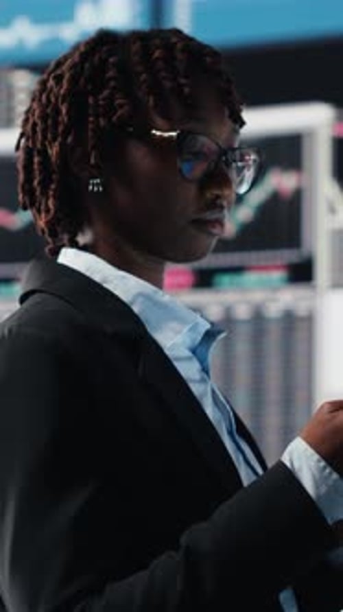 Vertical Video Business Manager Showing Graphs on Digital Screens at Event