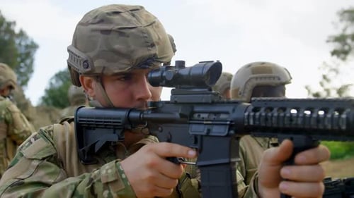 Rear view of Biracial military soldiers rifle training in fields during military training 4k