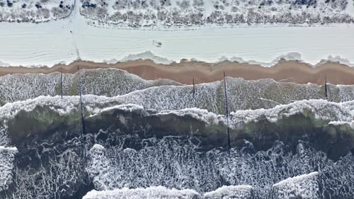 Snowy beach at Baltic sea. Aerial view of Poland