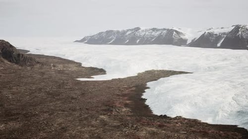 A Breathtaking View of a Glacier From the Summit of a Majestic Mountain