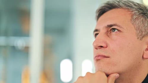 Contemplative Professional Male in Modern Office