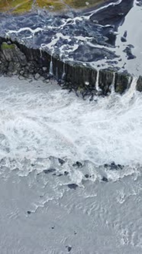 Aerial drone view of Dettifoss waterfall plunging into Jokulsargljufur canyon in Northeast Iceland.