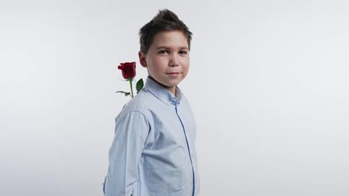 Boy Holding Rose Behind Back in Studio