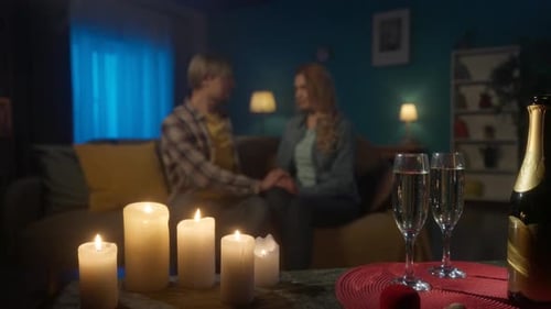 Couple Holding Hands During Romantic Evening at Home
