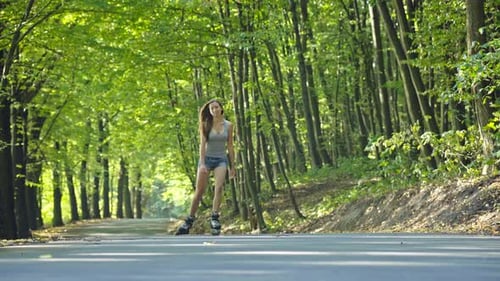 Beautiful Teenage Girl Rollerskating in Park