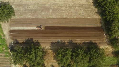 Tillage tractor ploughing at backcountry Northern California aerial