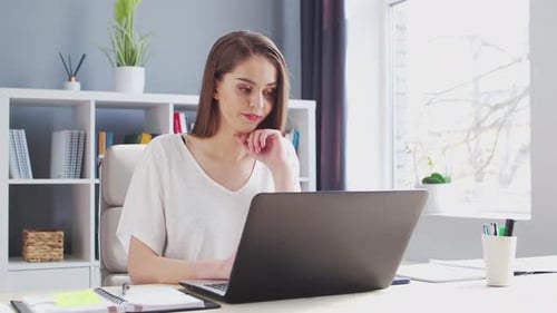Young Woman Works at Home Office Using Computer Workplace of Female Entrepreneur Freelancer or