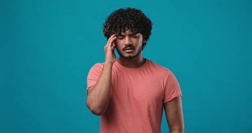 Young Man Massaging Temple Feeling Headache