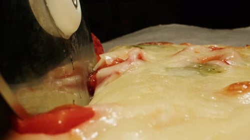 Close Up of Pizza Being Cut