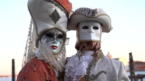 Masked Couple in Traditional Venetian Costumes at Sunset
